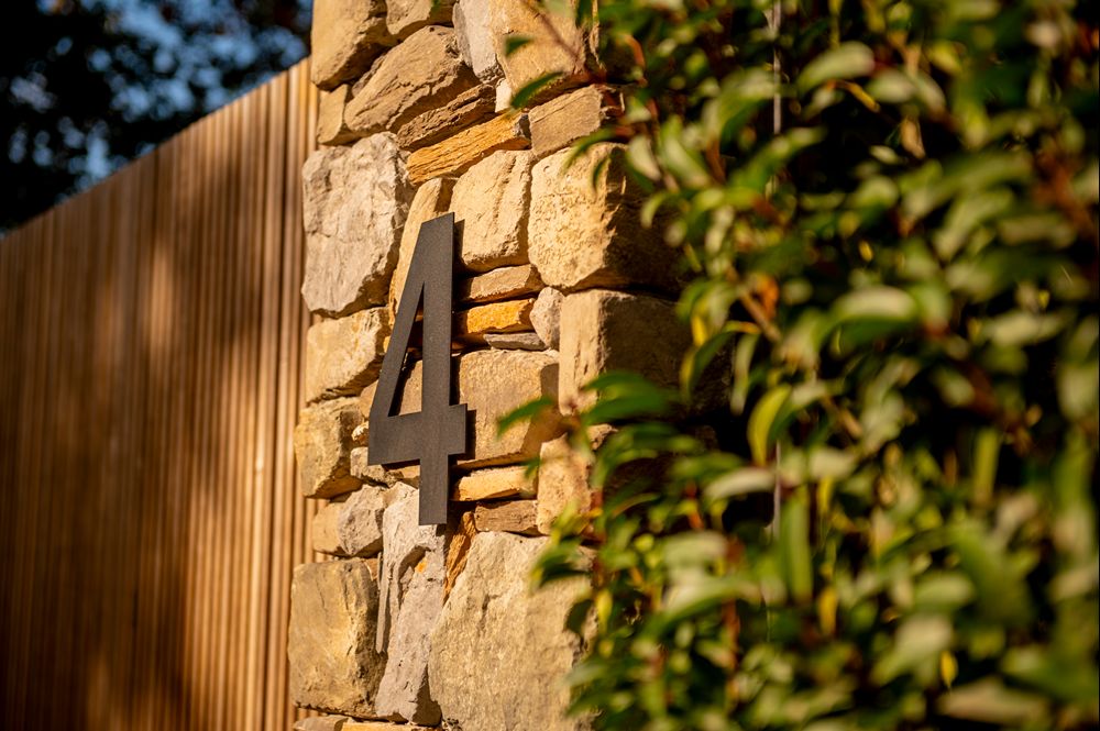 huisnummer met poort op de achtergrond